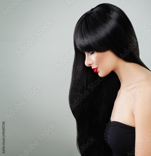 Long Hair Woman. Beautiful Model Girl with Healthy Hair on Gray Background photo