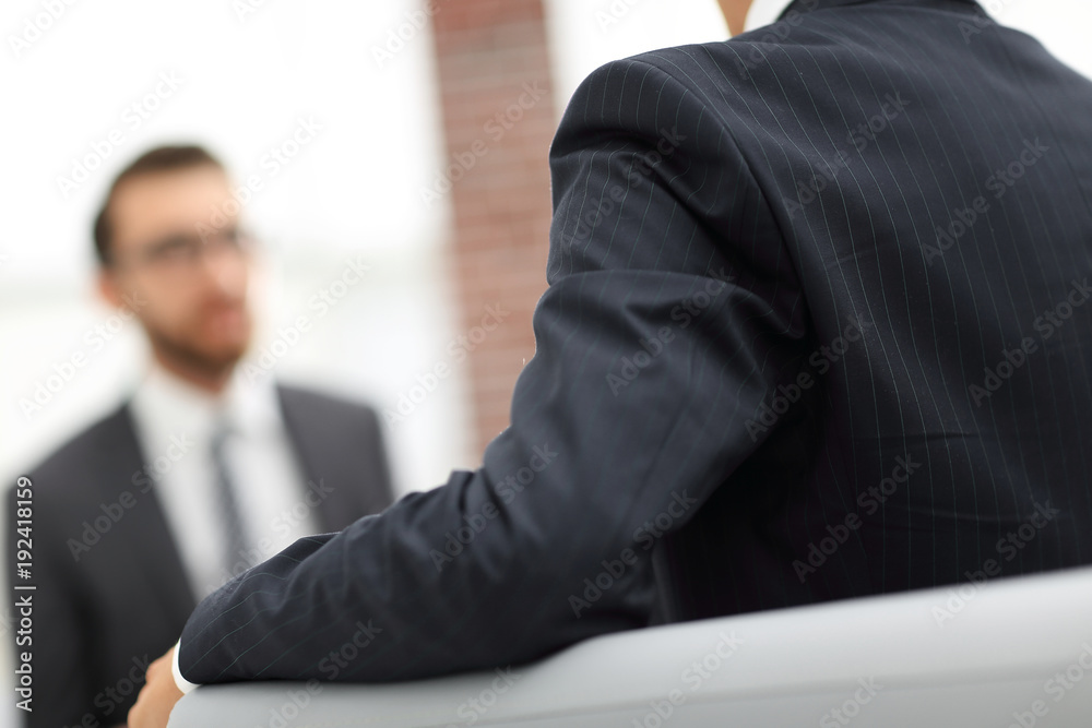 Image of young businessman communicating with his colleague Image of young businessman communicating with his colleague