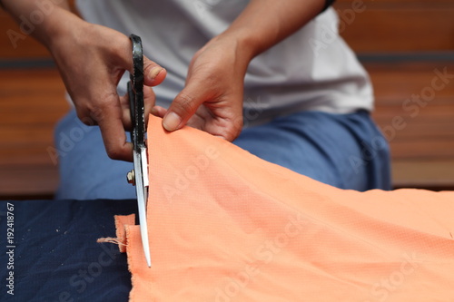 cutting cloth with scissors photo