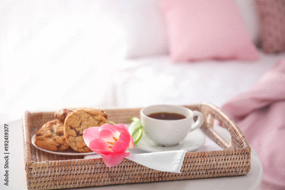 Tray with tasty breakfast and tulip on bed Tray with tasty breakfast and tulip on bed