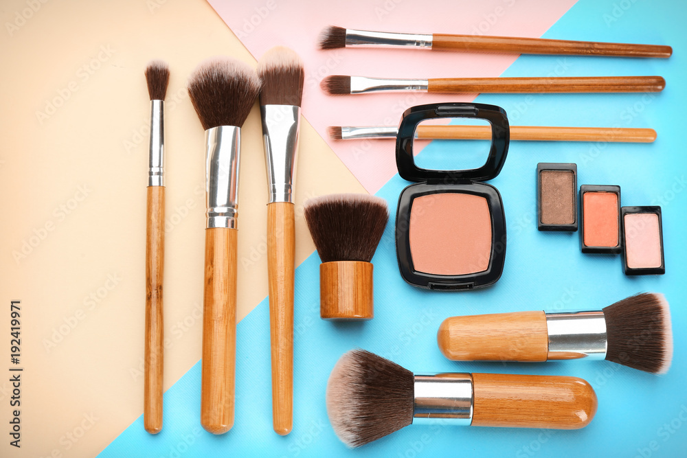 Decorative cosmetics and tools of professional makeup artist on color background Decorative cosmetics and tools of professional makeup artist on color background