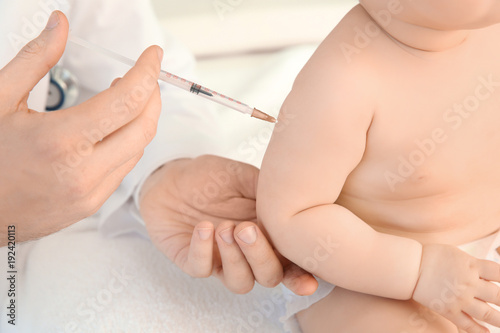 Doctor vaccinating little baby  closeup