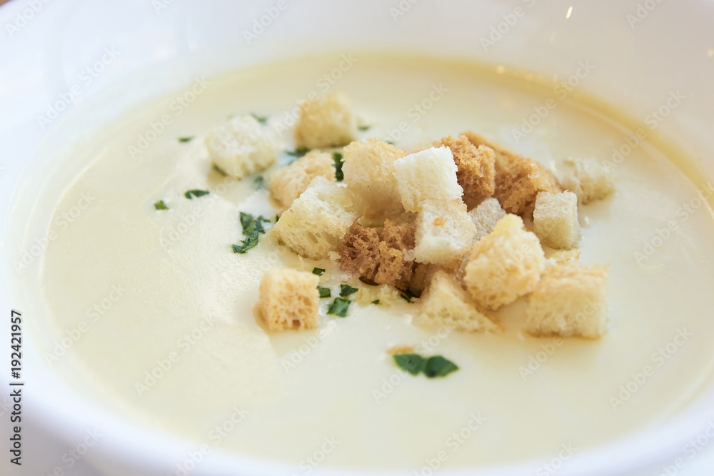 Small crackers. Delicious cheese soup. White dishes Small crackers. Delicious cheese soup. White dishes