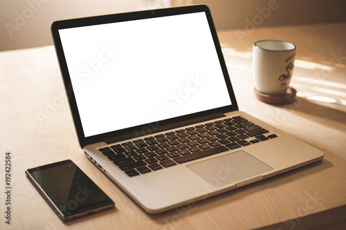 Close up view of a work desk interior with a laptop computer selective focus.