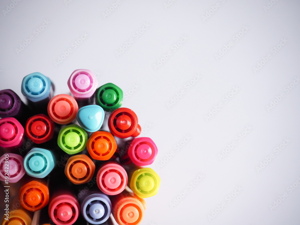 Top view Multi colored pens on a white background. Top view Multi colored pens on a white background.