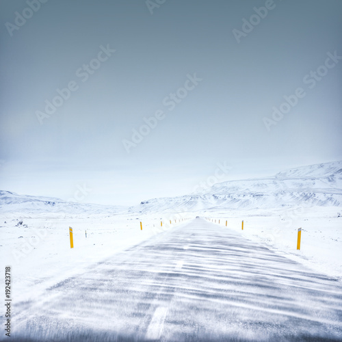 Winter road in iceland, wind and snow, blue sky © kovop58