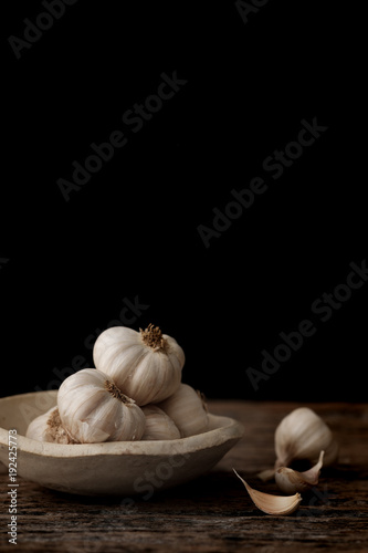 Still life of garlic bulb in dark black background