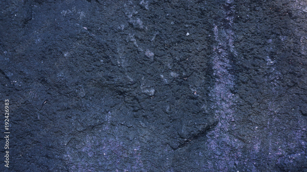 Naklejka premium Dark surface of a stone for a background.