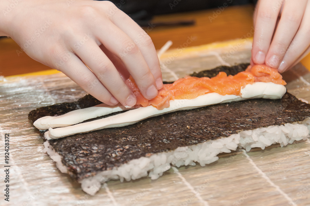 Children prepare sushi rolls. Master-class in the restaurant. Selective focus