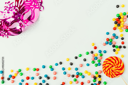 flat lay with arranged masquerade mask, lollipop and sweets isolated on white