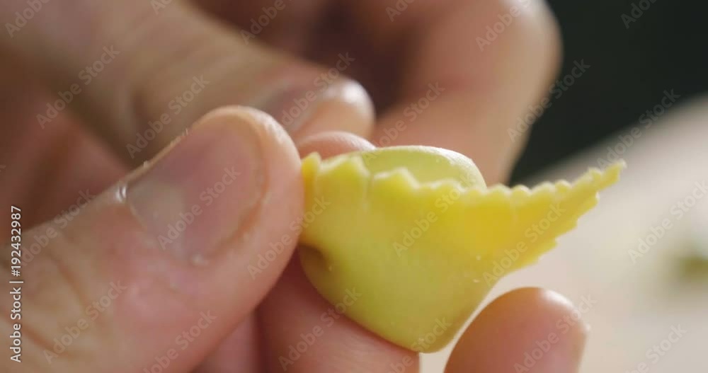 Close-up of a chef preparing ravioli, a typical Italian dish, homemade according to the ancient Italian tradition. Concept of: tradition, fresh pasta, italian food. Close-up of a chef preparing ravioli, a typical Italian dish, homemade according to the ancient Italian tradition. Concept of: tradition, fresh pasta, italian food.
