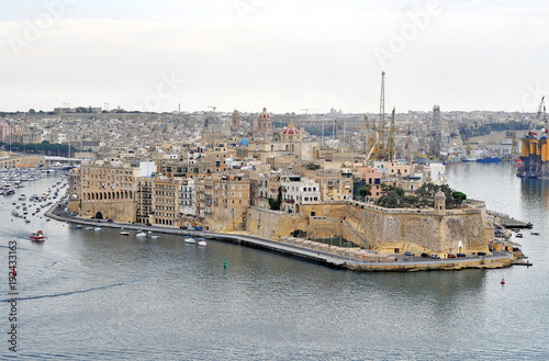 A beautiful port on the island of Malta with buildings, monuments and ships #192433163