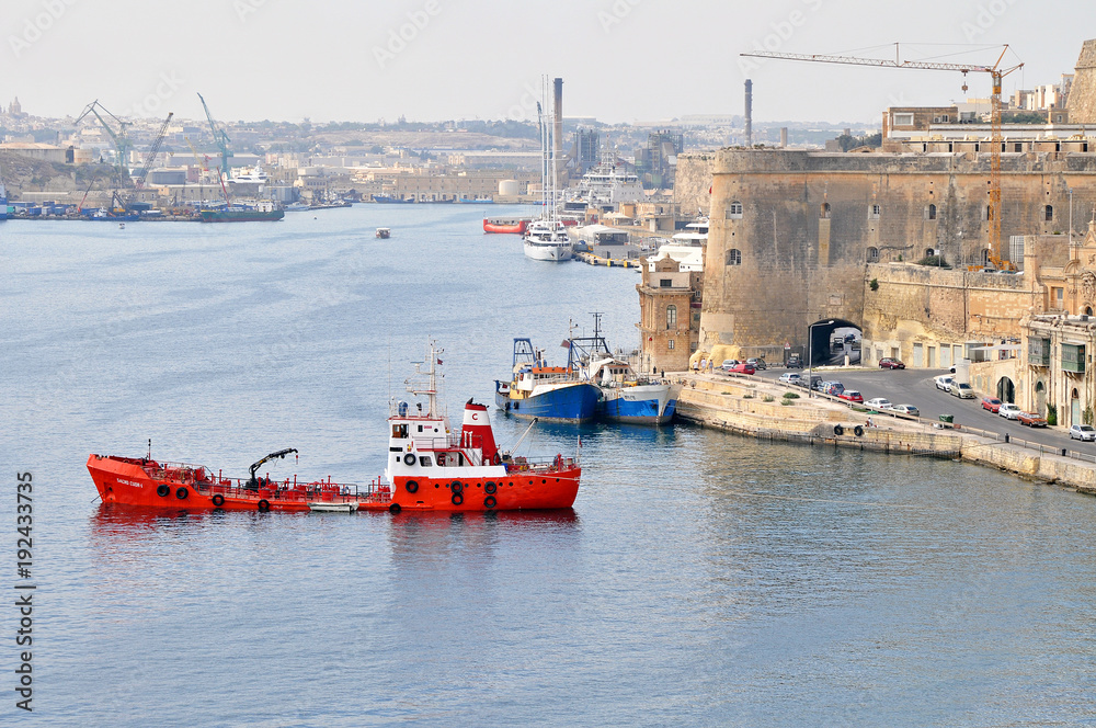 Port with ships on the picturesque island of Malta with beautiful monuments