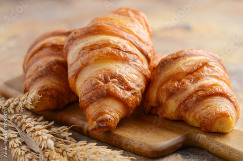 Fresh Croissants on a Wooden Cutting Board Selective Focus