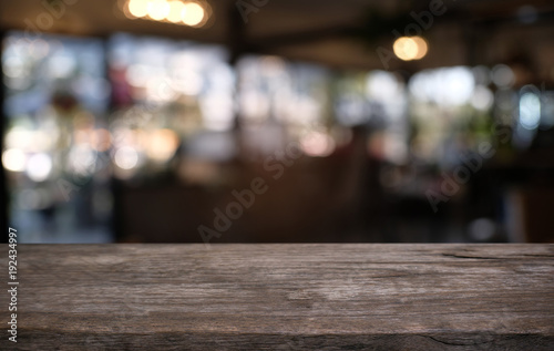 Empty wooden table in front of abstract blurred background of coffee shop . can be used for display or montage your products.Mock up for display