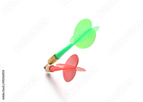 Red and green throwing darts isolated on white background