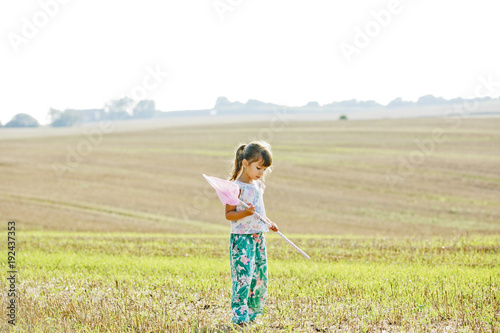 Girl with bug net in field in Friseboda, Sweden photo