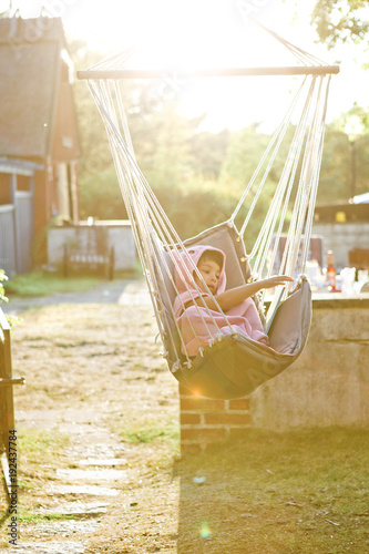 Girl in hammock at sunset in Friseboda, Sweden photo