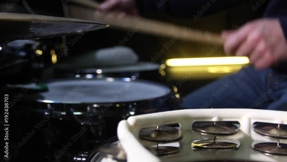 Close up of drum tambourine and a drummer playing on drums on background. Slider shot. Close up of drum tambourine and a drummer playing on drums on background. Slider shot.