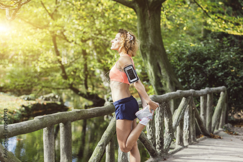 young fitness woman runner stretching legs before run