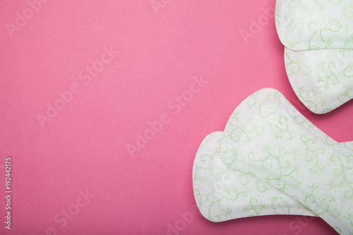 Women's sanitary pad on pink background. Empty copy space for text.