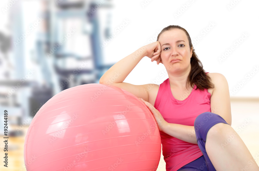 Tired and sad woman doing pilates exercises at gym Tired and sad woman doing pilates exercises at gym