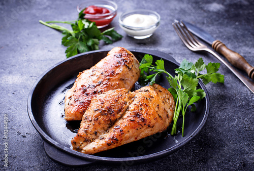 Grilled chicken breast or fillet on iron pan photo