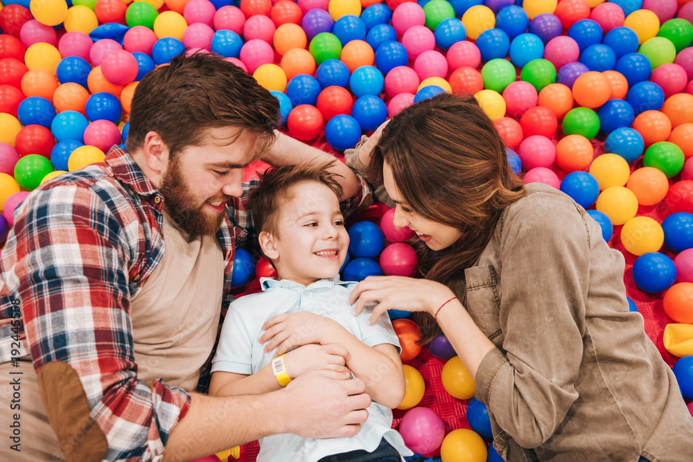 Smiling little child have fun with his parents