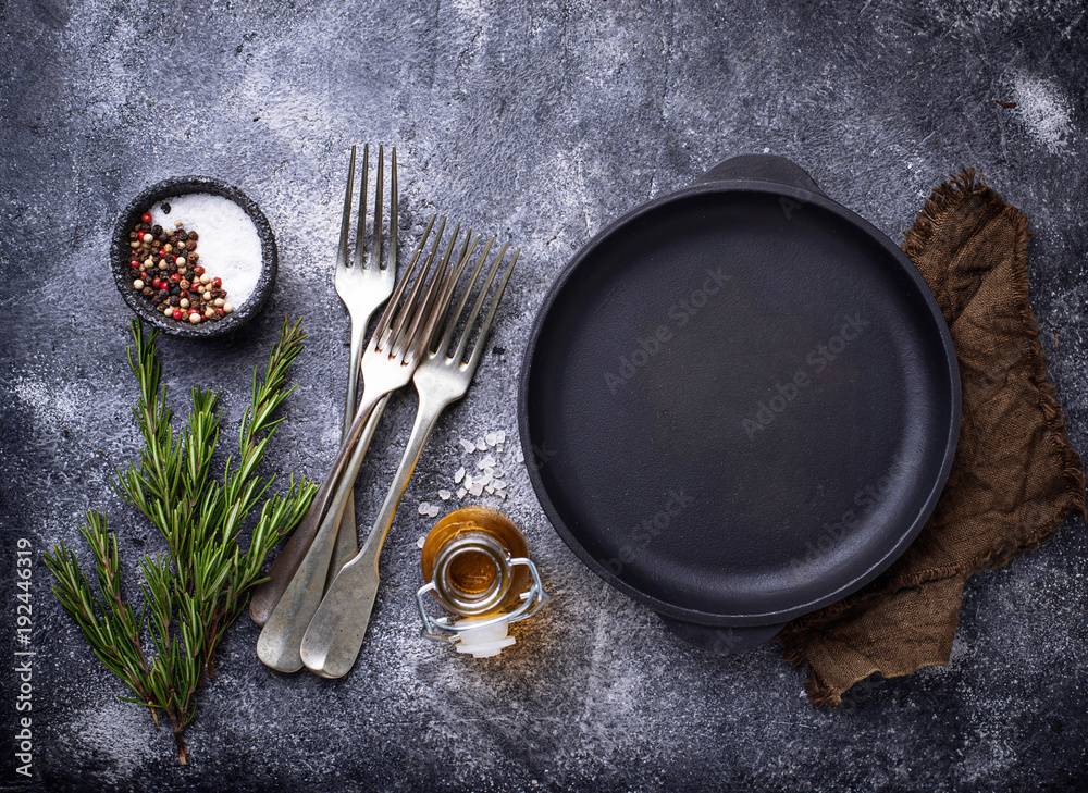 Cast iron frying pan with herbs and spices Cast iron frying pan with herbs and spices