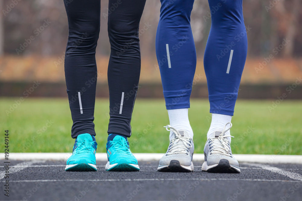 Fototapeta premium Front cropped view of two runners in running shoes.