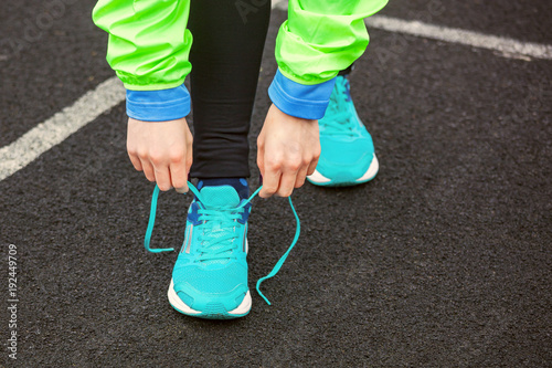 Cropped shot of a woman tying her shoelaces.