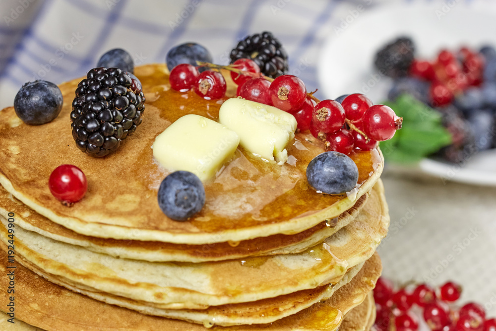  stack of pancakes with butter and berries