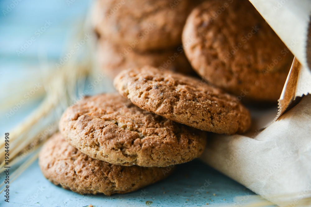 fresh oatmeal cookies in a bag made of paper on wooden background fresh oatmeal cookies in a bag made of paper on wooden background
