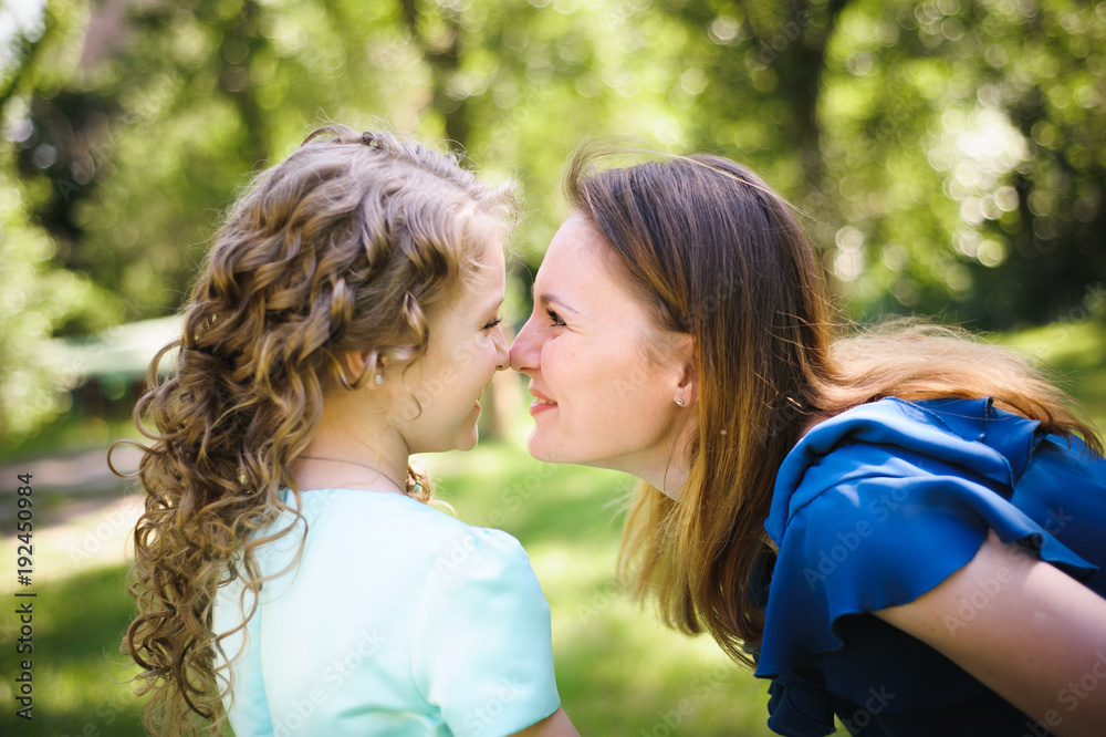 Happy mother and daughter together outdoors Happy mother and daughter together outdoors