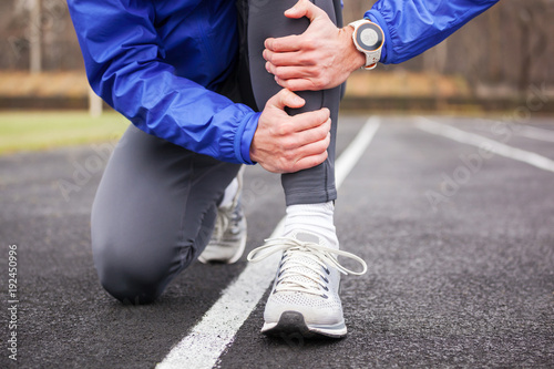 Cropped shot of a young runner holding his leg in pain.
