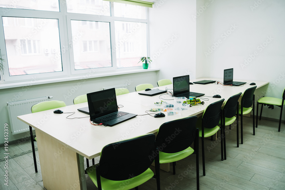 interior of classroom with laptops on desk at stem education courses interior of classroom with laptops on desk at stem education courses