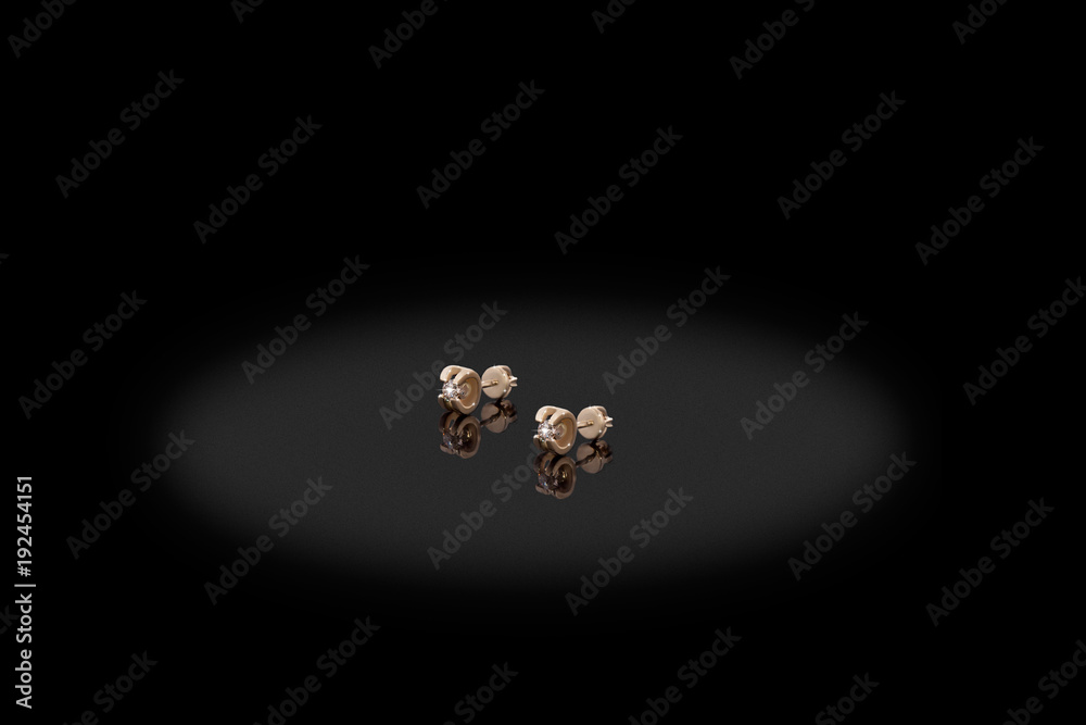 Yellow gold precious earrings with big diamonds on black background. Yellow gold precious earrings with big diamonds on black background.