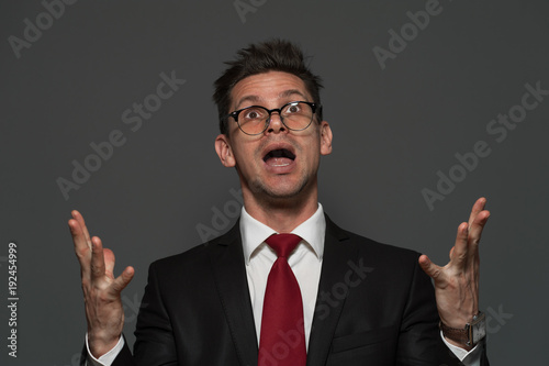 Photos Disheveled young man the manager in formal suit is pleased with unexpected succe