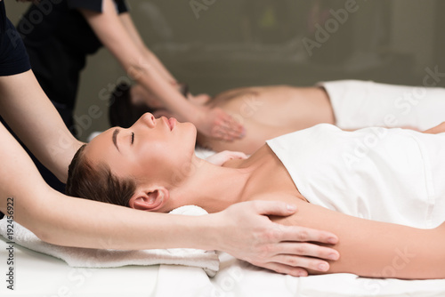 side view of couple having massage in spa salon