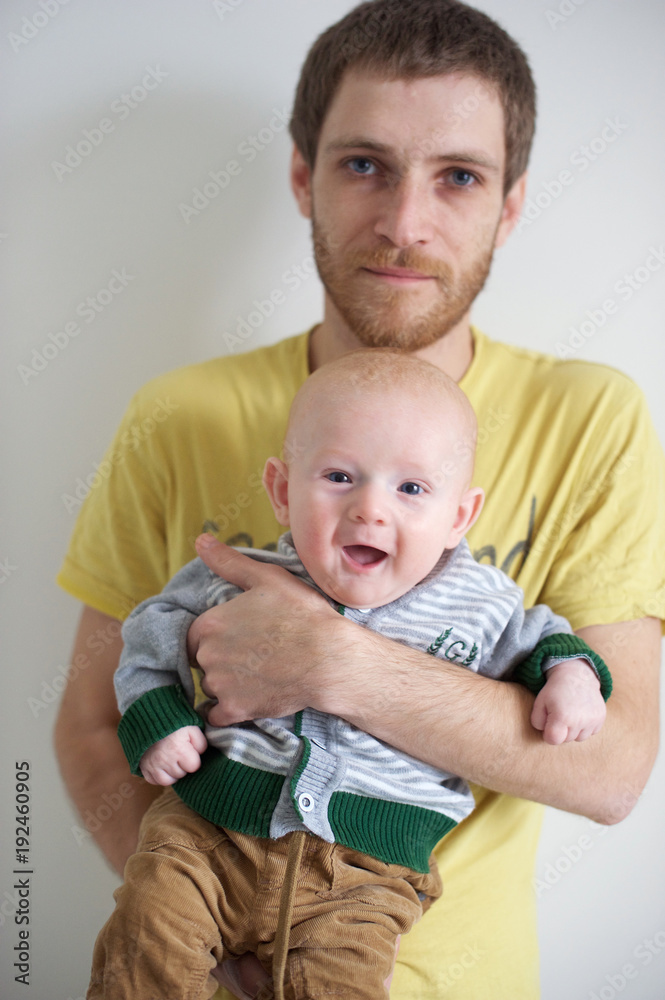 Father holds a baby in his arms Father holds a baby in his arms