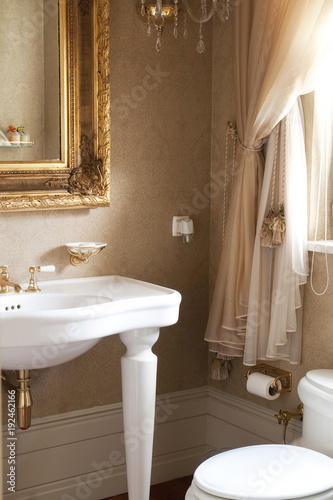 modern classic bathroom white details and gold mirror style. decorative bath concept.