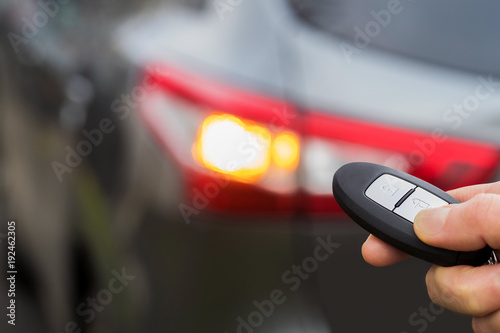 Close Up Of Driver Activating Car Security System With Key Fob