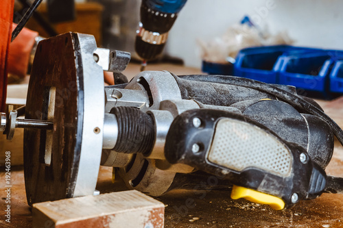 Processing of a furniture part by a machine for polishing a tree. the grinding machine on a board, selective focus.