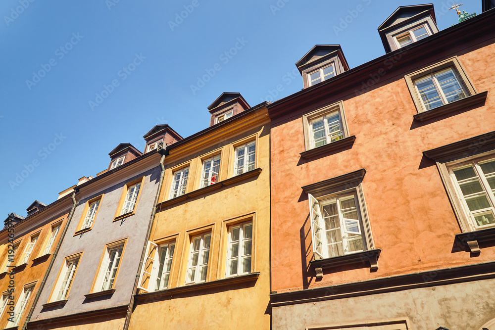 Fototapeta premium Facades of old town houses in Warsaw, Poland against the blue sky