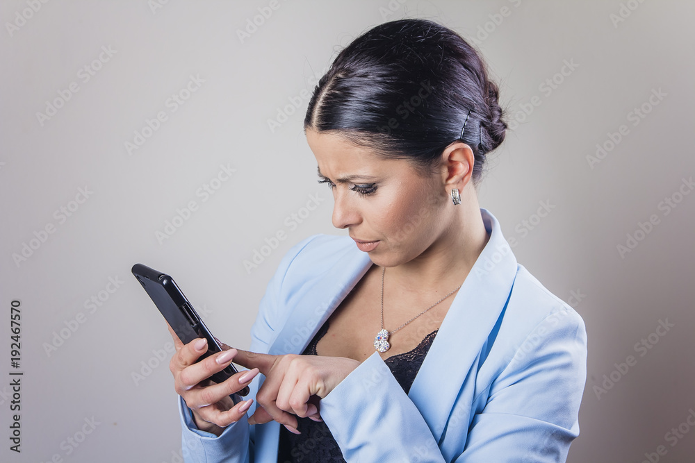 Modern young business woman using her cell phone, swiping through internet or social media Modern young business woman using her cell phone, swiping through internet or social media