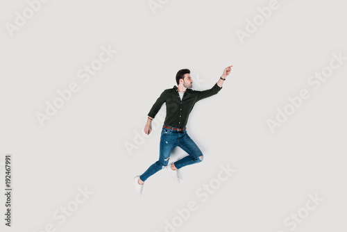 top view of handsome young man jumping isolated on white