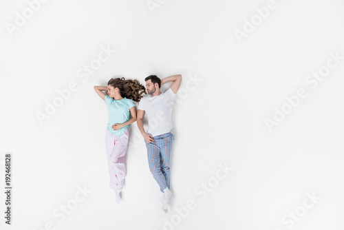 top view of couple in pajamas sleeping together isolated on white