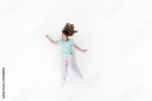 top view of young woman in pajamas sleeping isolated on white