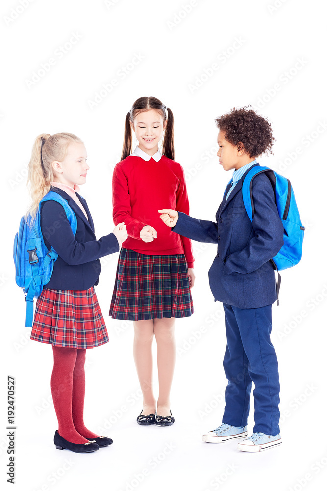 Studio portrait of multi-ethnic school friends wearing uniform Studio portrait of multi-ethnic school friends wearing uniform