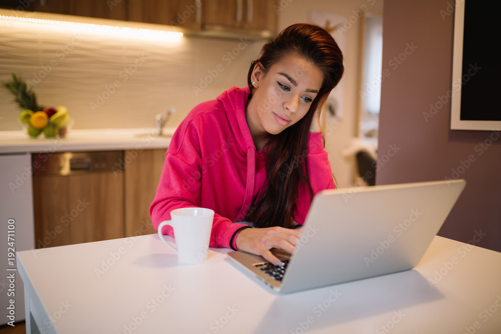 Young woman using laptop computer at home.